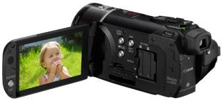 Canon Legria HF S21 camcorder with flip-out screen displaying a child.