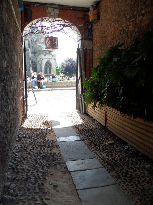 Photograph taken with Samsung ST5000 showing a stone pathway and archway.