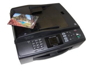 Brother MFC-J415W printer with a printed photo.