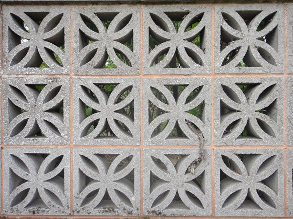 Decorative concrete block wall with a geometric pattern.