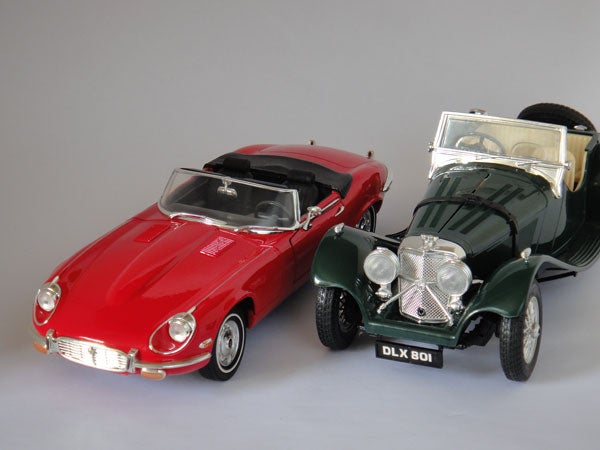 Two vintage model cars on display