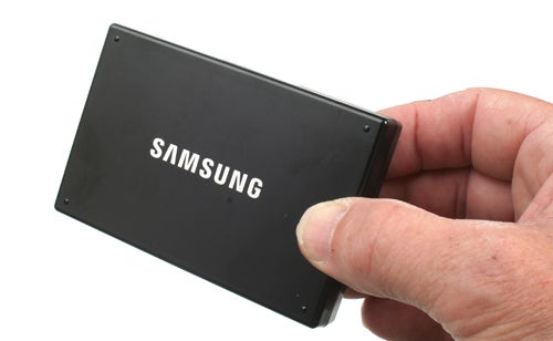 Hand holding a Samsung branded solid-state drive.
