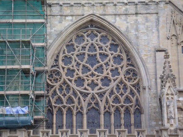 Intricate stone window design on a historic building facade.