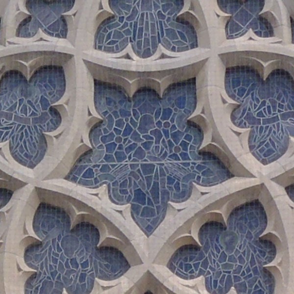 Decorative stone carving with blue stained glass.