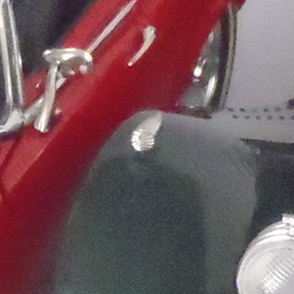 Close-up of water droplets on a red Olympus mju-Tough 6020 camera.