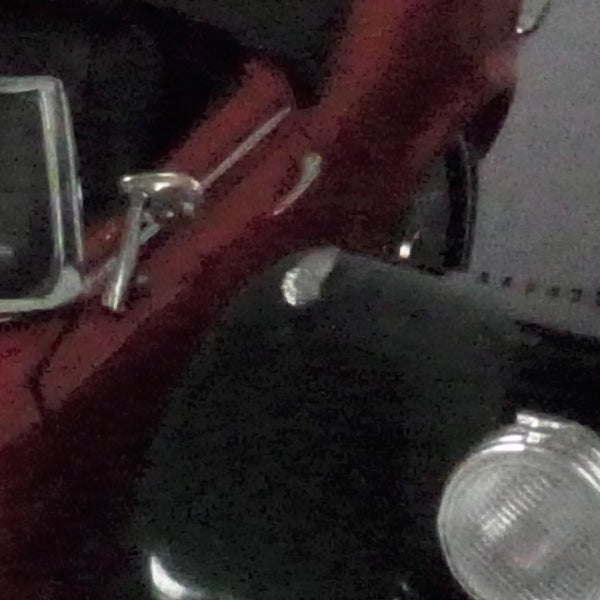 Close-up of a red vehicle captured with a Ricoh GXR camera.
