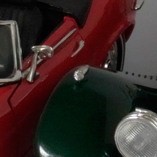 Close-up of a classic red and green car model