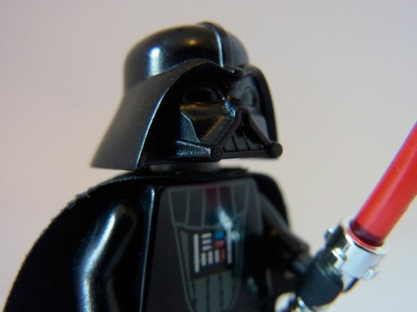 Close-up of a Darth Vader action figure with lightsaber