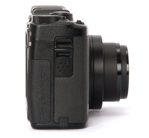 Side view of a black Ricoh GXR camera with lens attached