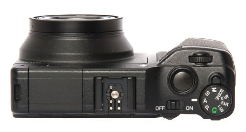 Ricoh GXR camera body with lens attached from side view.