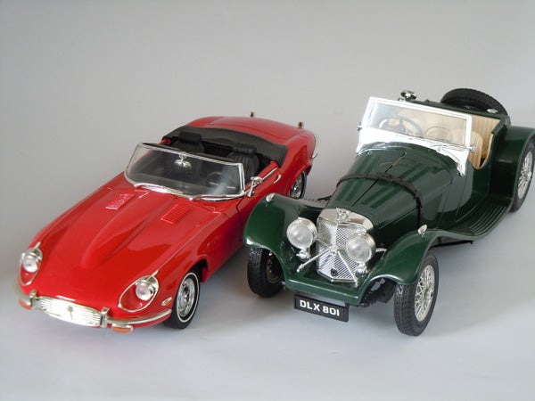 Diecast model cars, a red convertible and a green classic.