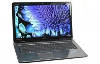 Dell Inspiron 17R laptop with screen displaying flower wallpaper.