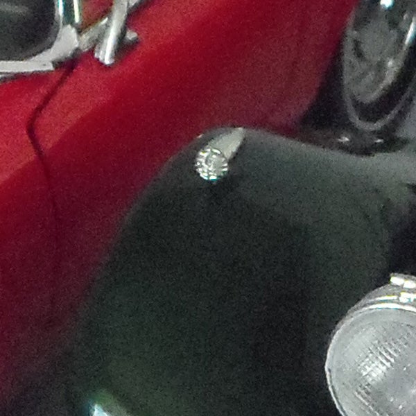 Close-up of a motorcycle tank and chrome detailing.