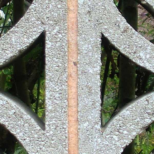 Close-up of a textured metal pattern with a green background.