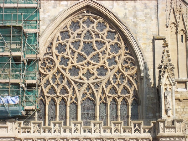 Detailed stone window facade of a Gothic cathedral.