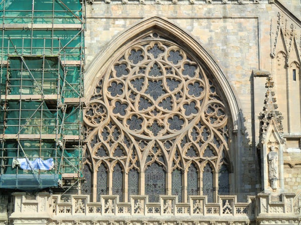 Detailed gothic church window architecture with scaffolding.