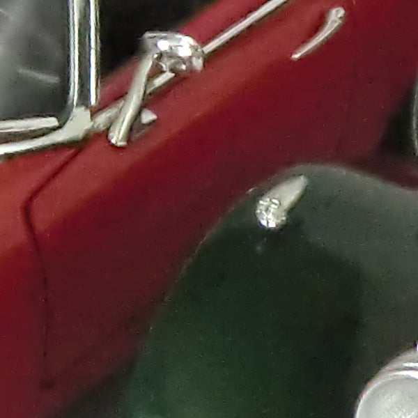 Close-up of a shiny object with unclear background.