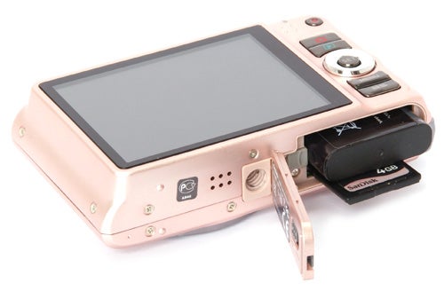 Casio Exilim EX-H15 camera in pink with open battery compartment.
