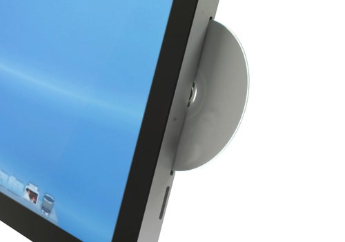 Close-up of Apple iMac 21.5-inch 2010 model with inserted CD.
