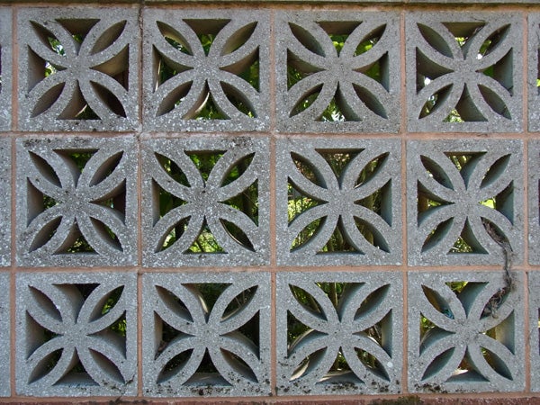 Decorative concrete block wall with snowflake-like patterns.