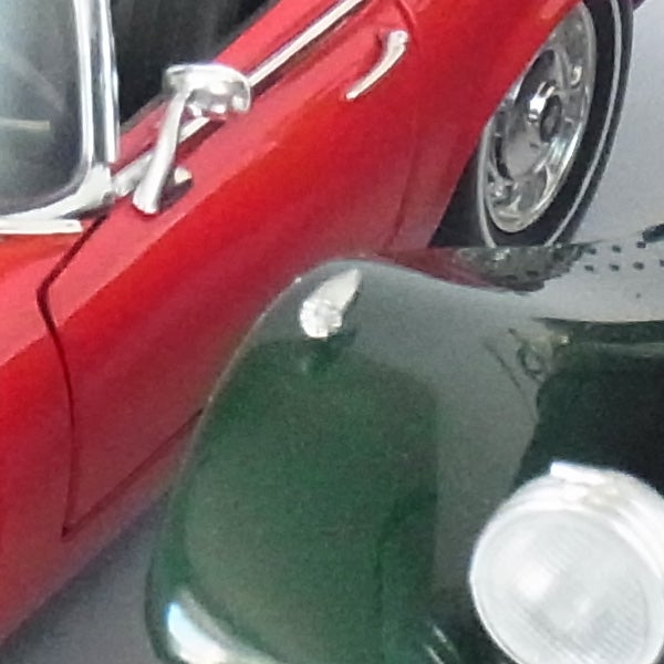 Close-up photo of red and green toy cars.