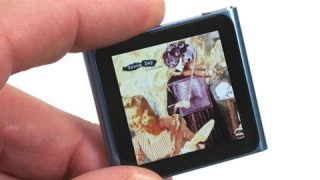 Hand holding iPod Nano 6th Generation displaying album cover.
