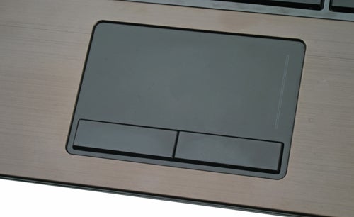 Close-up of HP ProBook 5320m laptop touchpad and buttons.