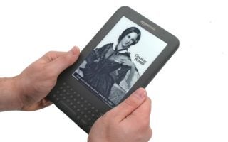 Person holding an Amazon Kindle 3 displaying an e-book.