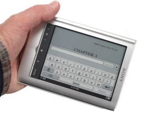 Hand holding a Sony Pocket Reader PRS-350 displaying text.