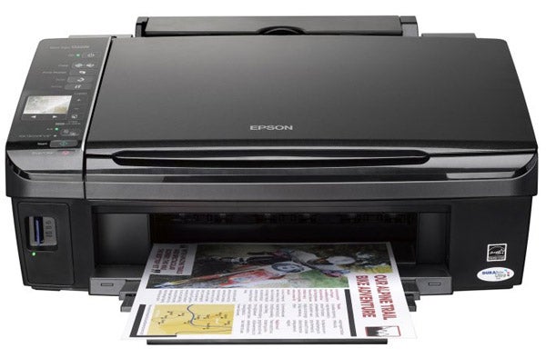 Epson Stylus SX425W printer with printed documents.