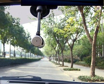 Chilli Technology Action Cam mounted in car with road view.