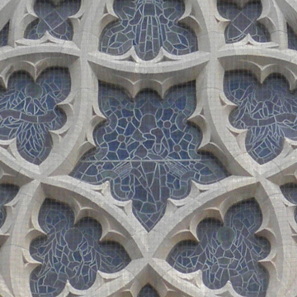 Close-up of intricate stone window tracery design.