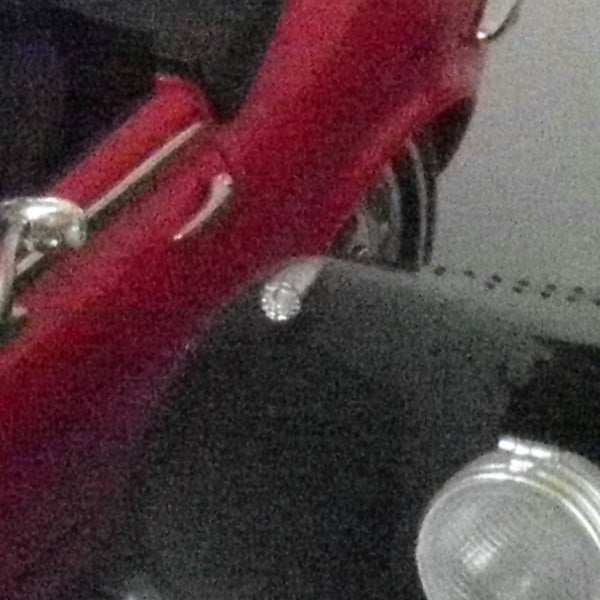 close-up of a red object with metallic parts