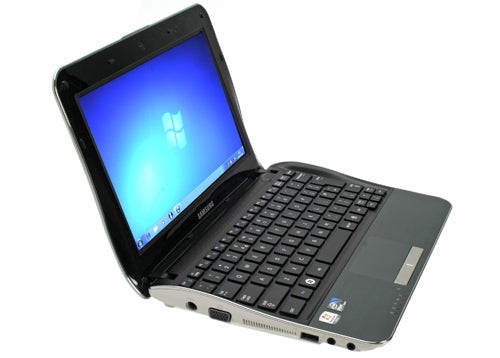 Samsung NF210 netbook with open lid displaying desktop.