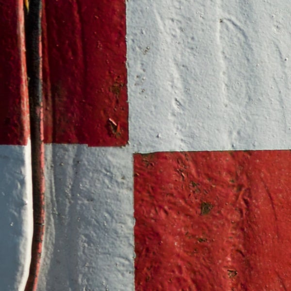Close-up of textured red and white painted surfaces.