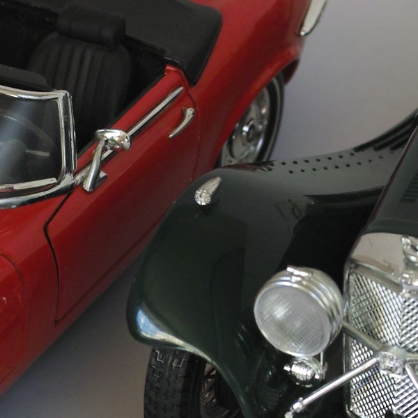 Close-up photo of miniature red and black vintage cars.