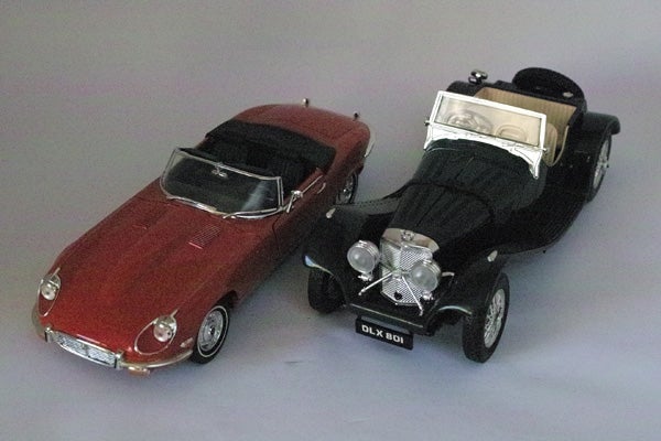 Two vintage model cars on display.