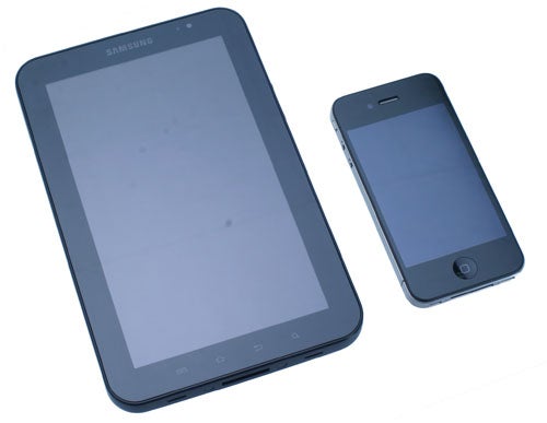Samsung Galaxy Tab next to a smartphone on white background.