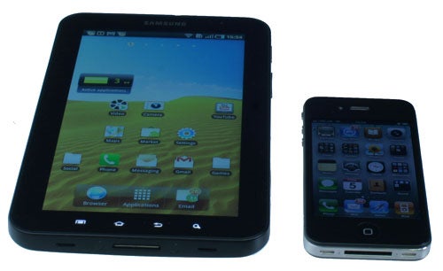 Samsung Galaxy Tab next to a smartphone for size comparison.