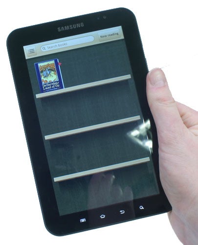 Hand holding a Samsung Galaxy Tab displaying an e-reader app.