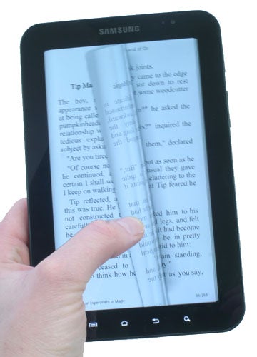 Hand holding a Samsung Galaxy Tab displaying an e-book.