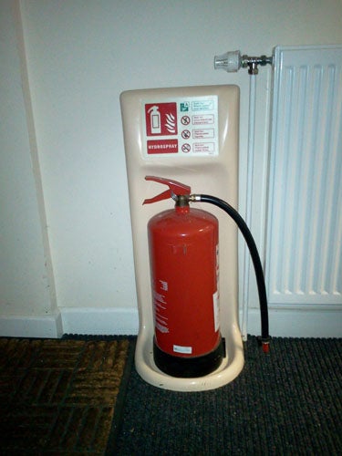 Office desk with computer setup, papers, and telephoneFire extinguisher standing in a corner of a roomFire extinguisher mounted on a stand near a radiator.screenshot of Samsung Galaxy Tab specifications and review.