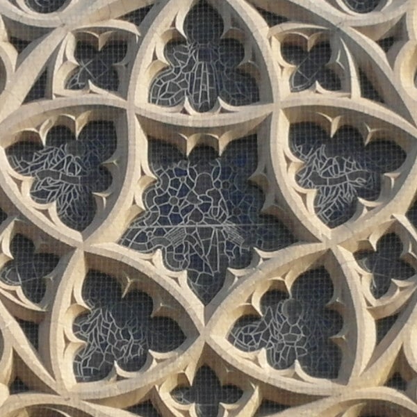 Intricate stone lattice work with floral patterns.