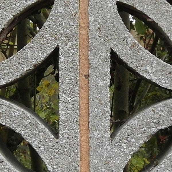 Close-up of intricate metalwork with natural background