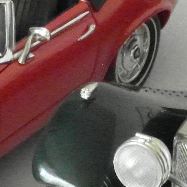 Close-up of a vintage red car photographed with Samsung WB2000.