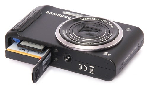 Samsung WB2000 digital camera with opened battery compartment.
