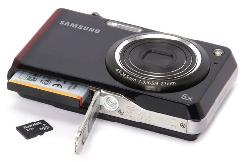 Samsung PL150 digital camera with open battery compartment.