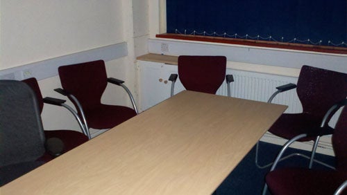 Empty meeting room with chairs and a table.