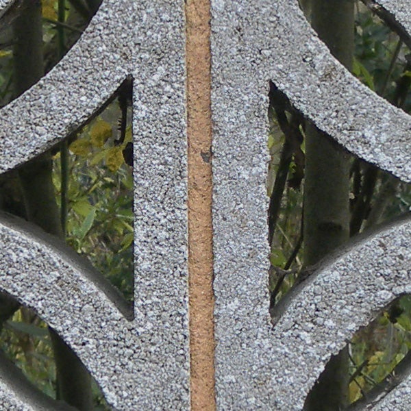 Close-up of a frost-covered metal fence design.