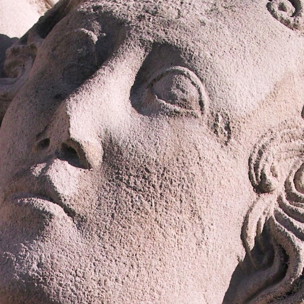 Close-up photo of a stone sculpture's face.